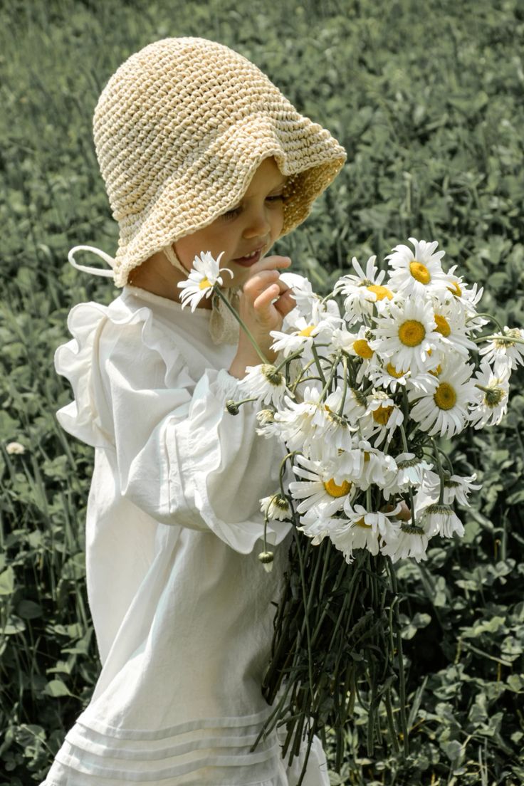 Toddler girl in vintage white frock in nature
