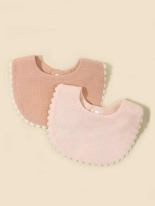 Beige and brown baby bibs with scallop trim and snap buttons
