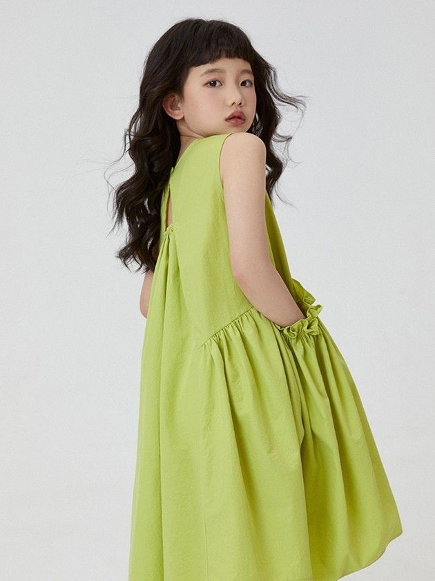 Bold lime girl’s dress with sporty sandals
