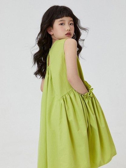 Bold lime girl’s dress with sporty sandals
