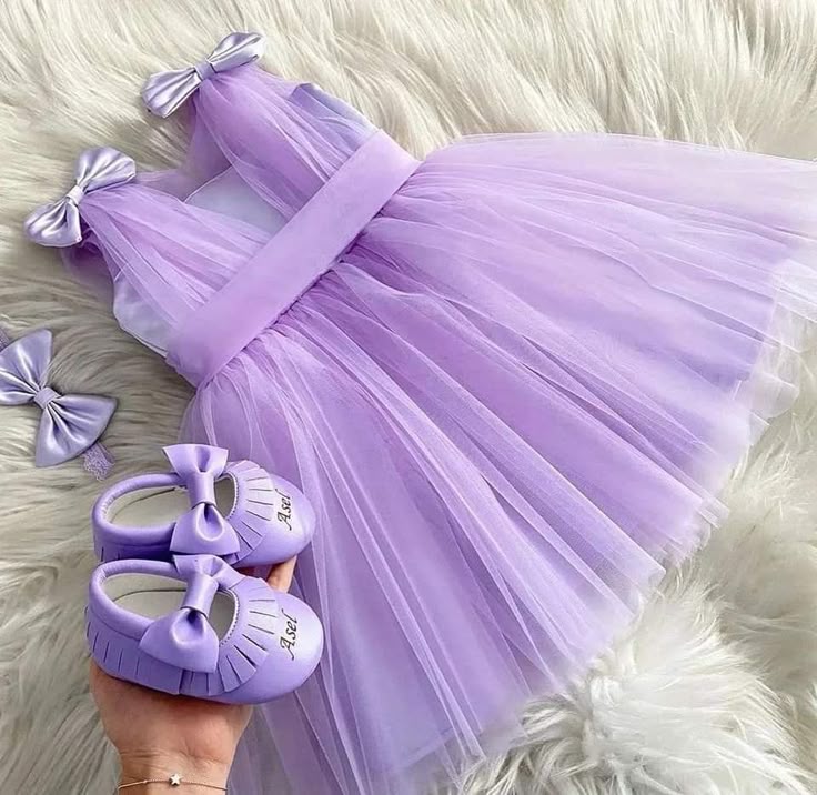 Lavender party dress for baby girl with satin bows and matching shoes
