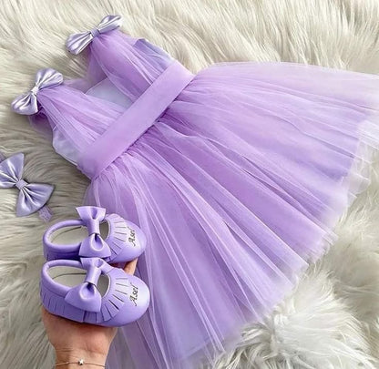 Lavender party dress for baby girl with satin bows and matching shoes
