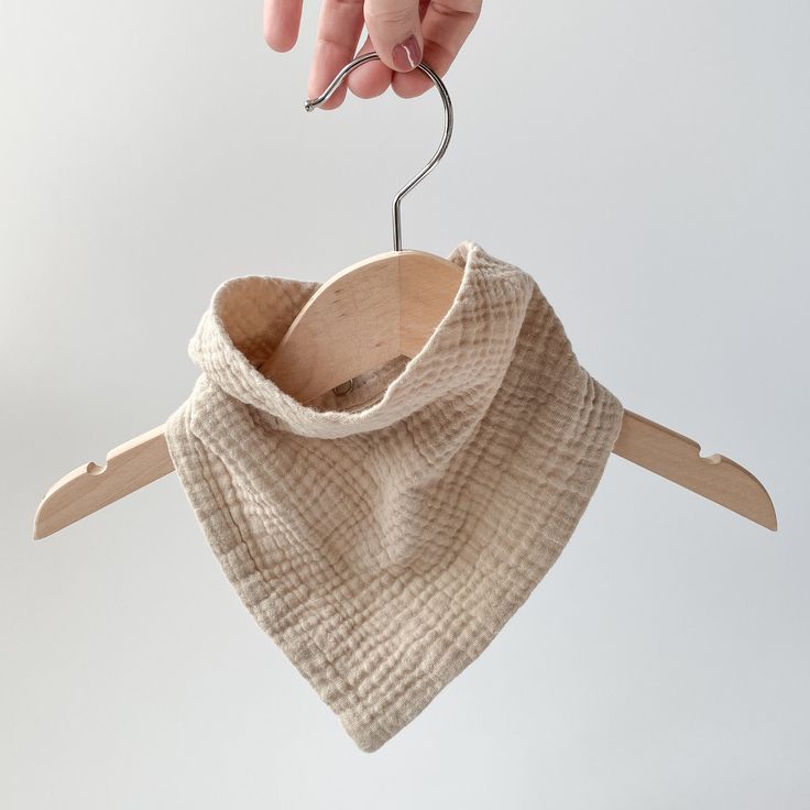Cotton muslin drool bib on kids hanger


