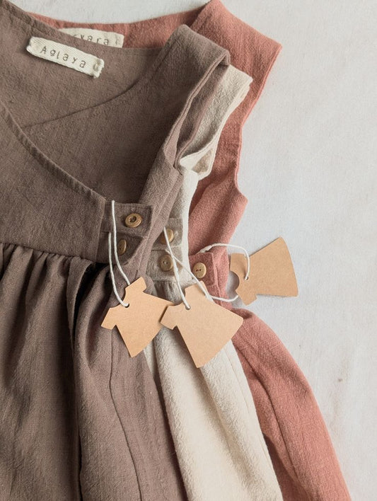 Minimalist toddler wrap dress on hanger
